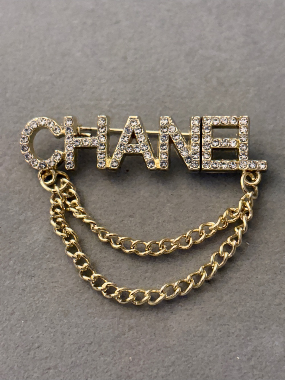 Gold-Tone Crystal Logo Chain Brooch
